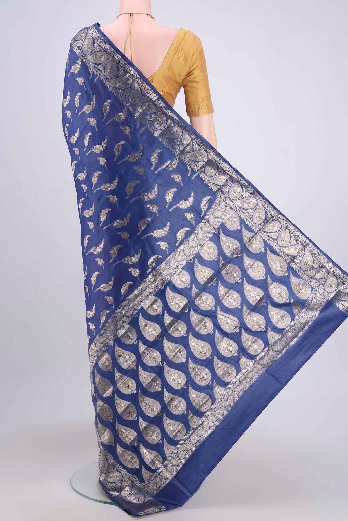 Flat view of Royal Blue Banarasi Tussar Silk Saree with Zari Butta on the body and Zari Border. 