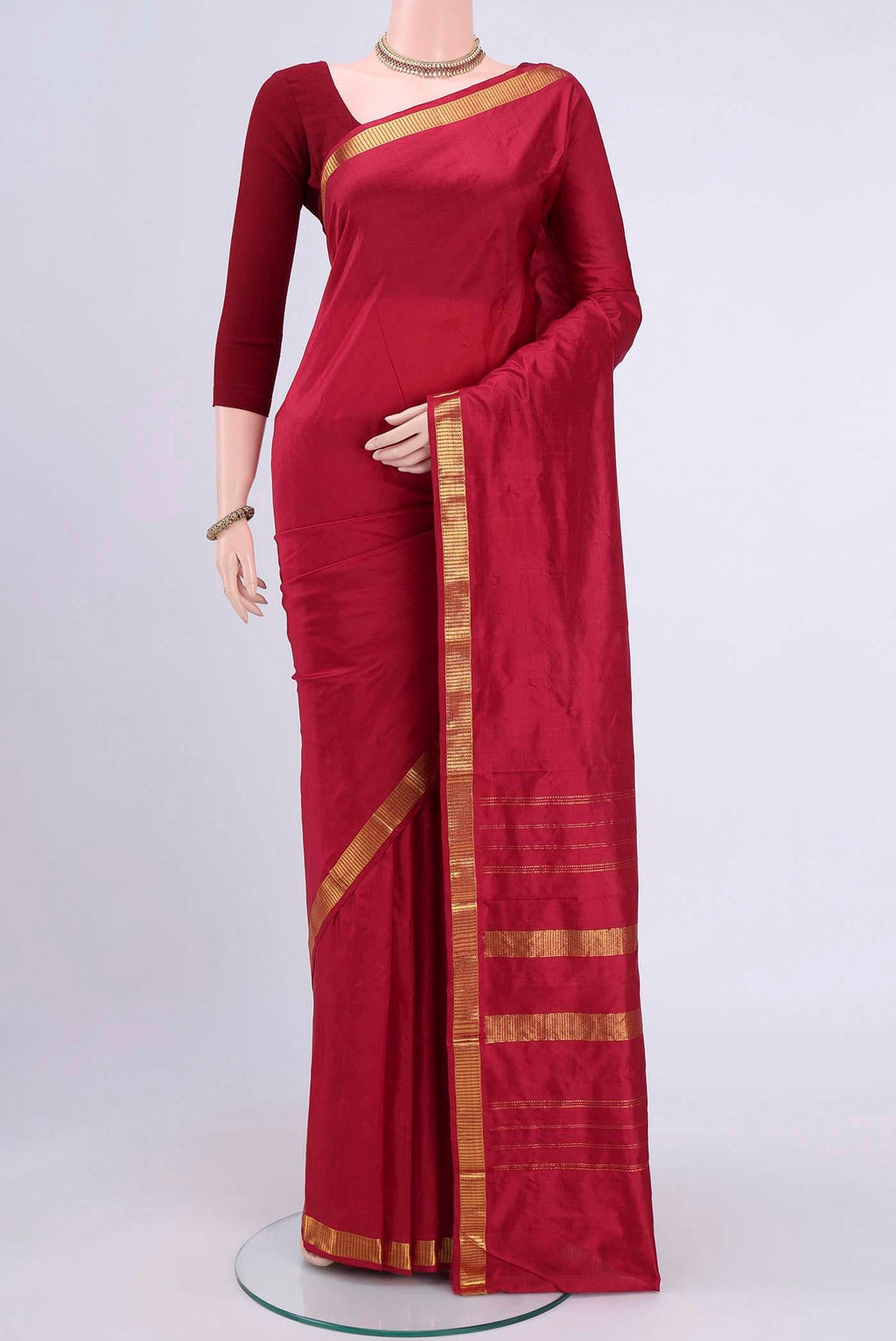 Red Kanchipuram Saree with Plain Body and Zari Border displayed on a mannequin