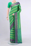 Mint Green Pochampally Saree with Ikat Print on the body and Ikat Border displayed on a mannequin