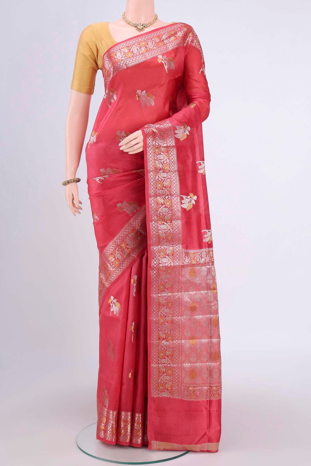 Peach Banarasi Raw Silk Saree with Zari Butta on the body and Zari Border.  displayed on a mannequin