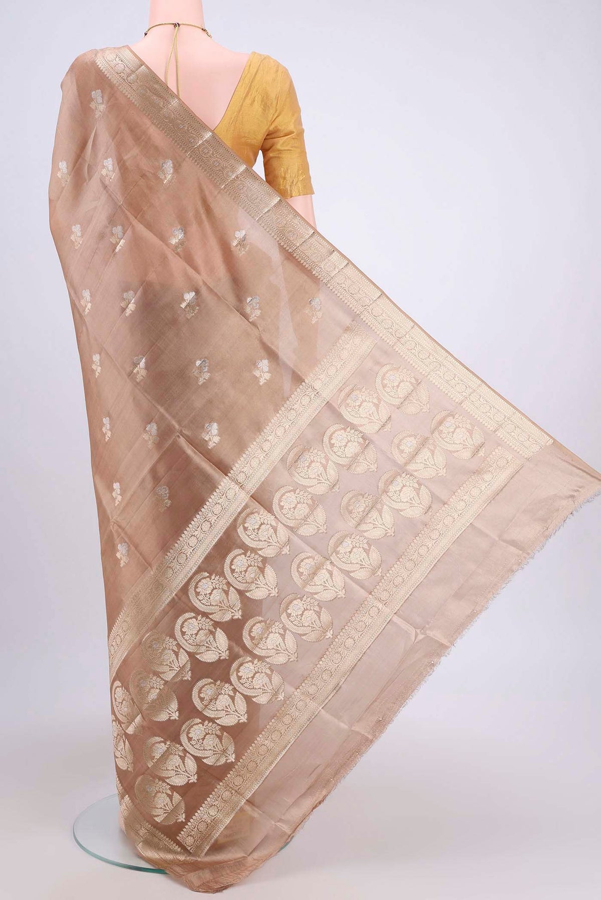 Flat view of Beige Banarasi Raw Silk Saree with Zari Butta on the body and Zari Border. 