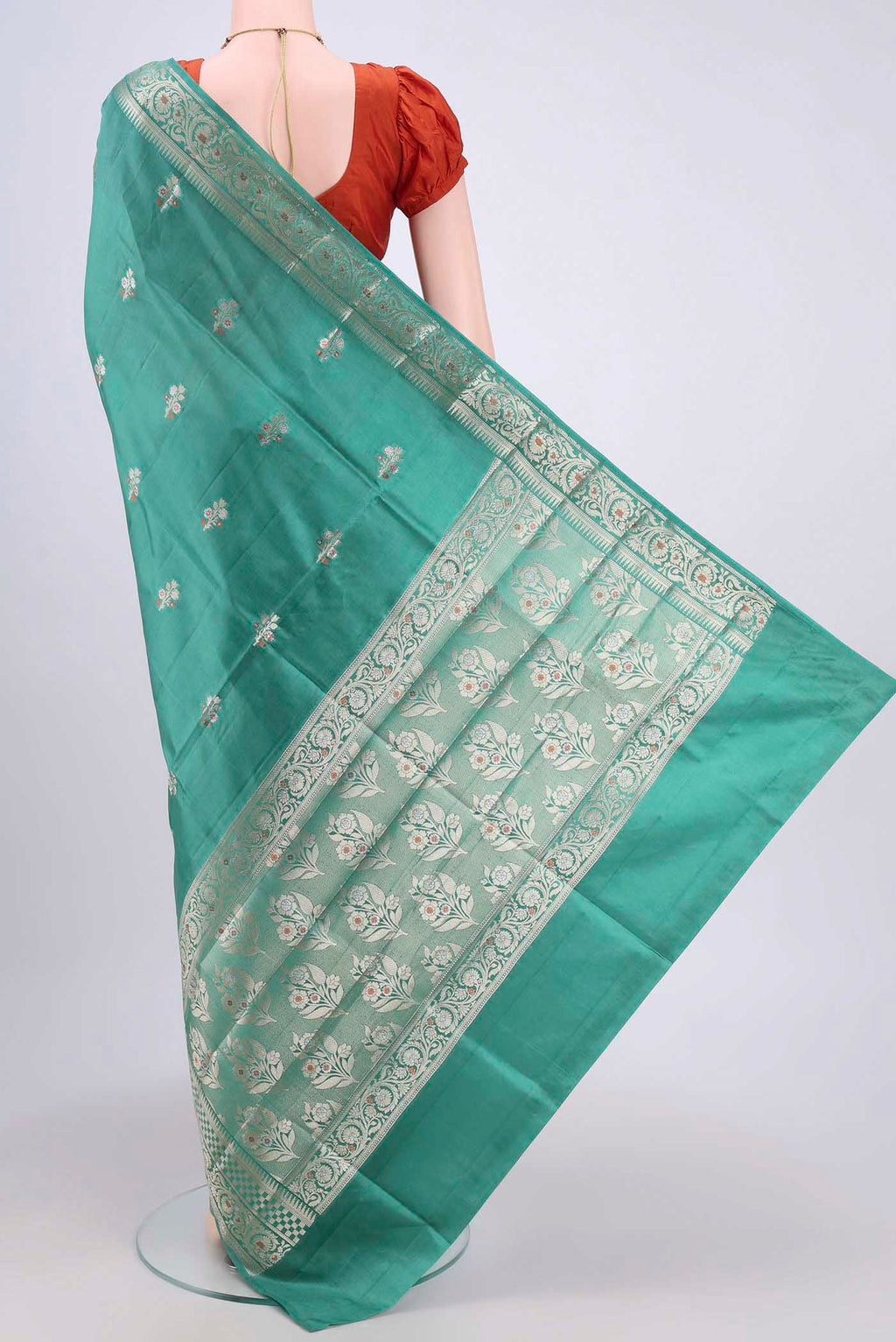 Flat view of Sea Green Banarasi Raw Silk Saree with Zari Brocade on the body and Zari Border. 