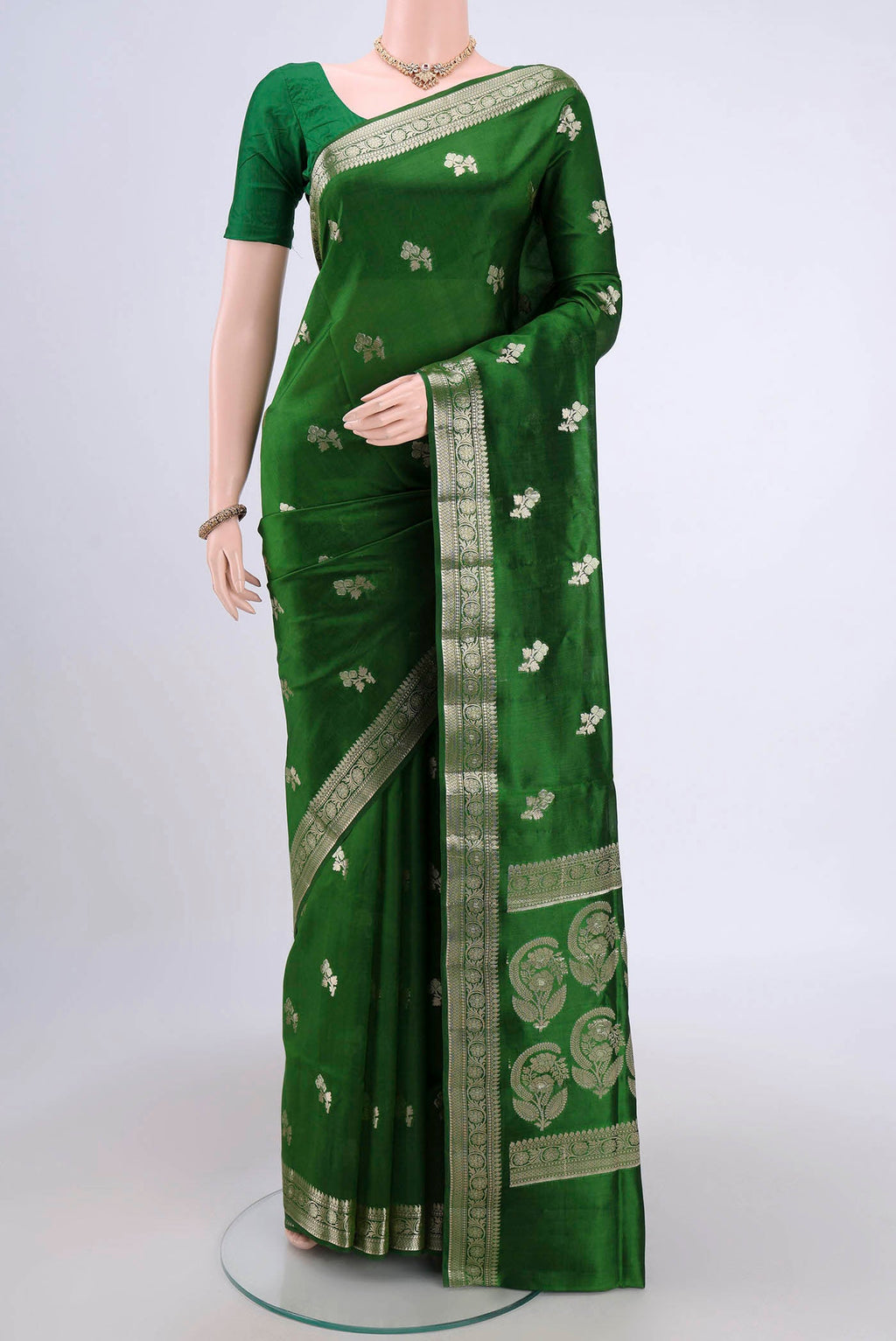 Green Banarasi Raw Silk Saree with Zari Butta on the body and Zari Border.  displayed on a mannequin