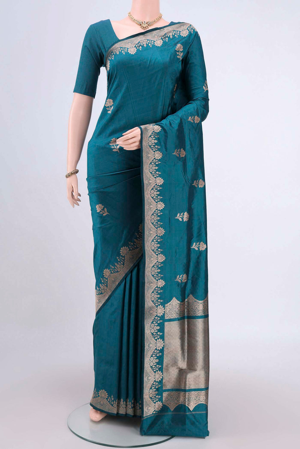 Sea Green Banarasi Katan Silk Saree with Zari Butta on the body and Zari Border.  displayed on a mannequin