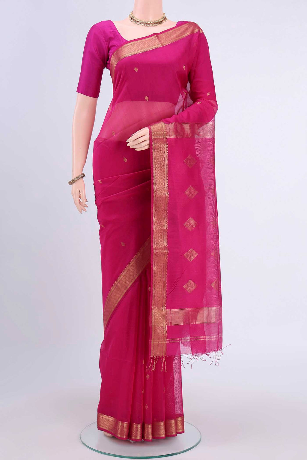 Rani Pink Maheshwari Silk Cotton Saree with Zari Butta on the body and Zari Border displayed on a mannequin