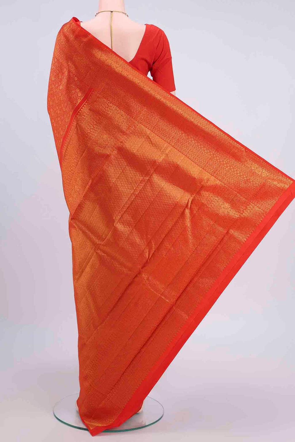 Flat view of Orange Kanchipuram Silk Saree with Zari Brocade on the body and Zari Border
