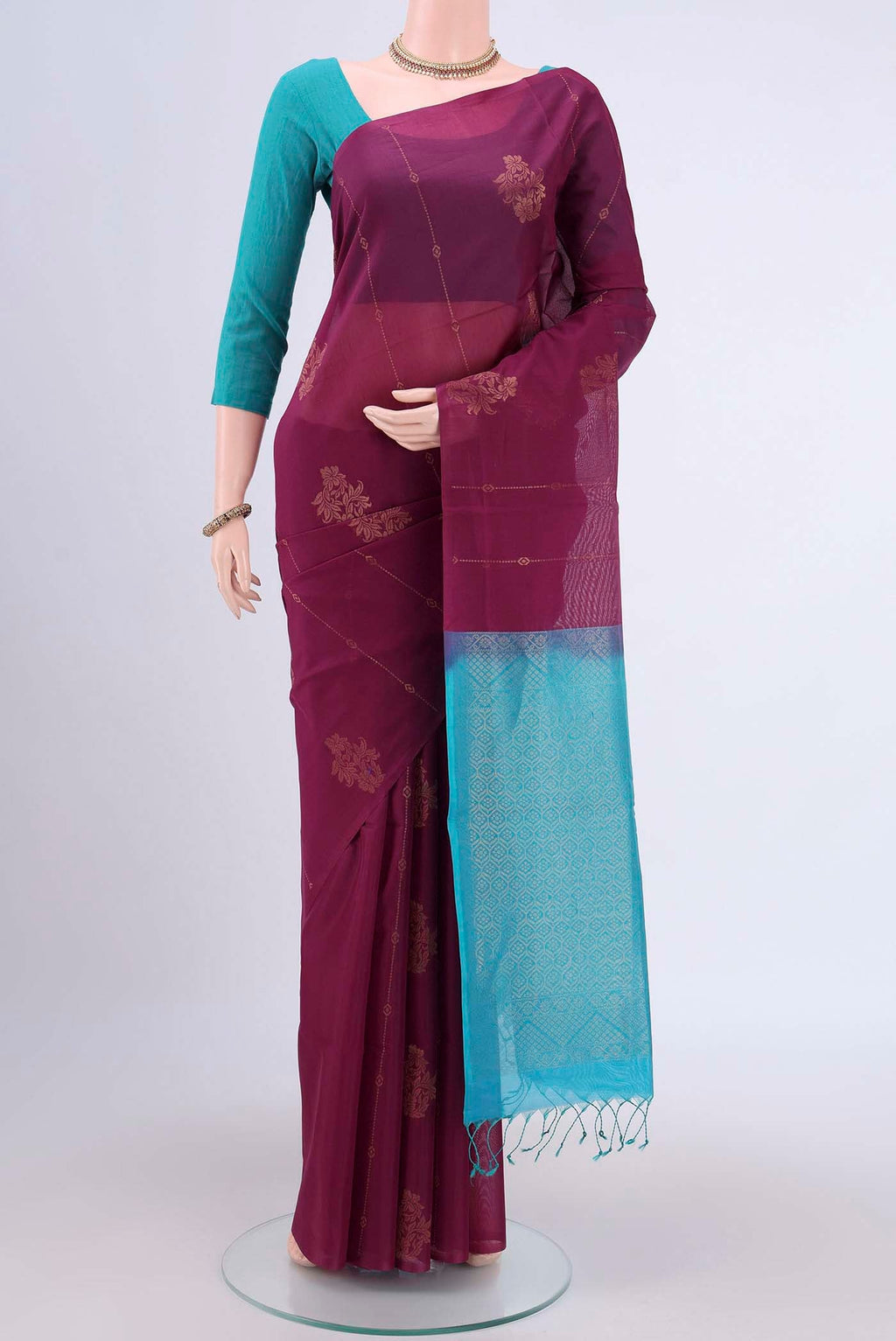 Mauve Kora Cotton Saree with Zari Butta on the body and Zari Border.  displayed on a mannequin