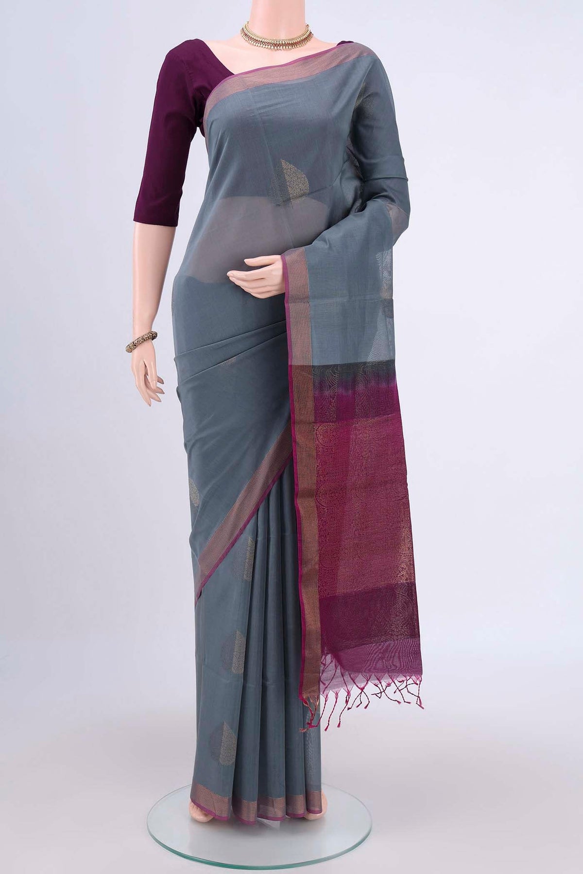 Grey Kora Cotton Saree with Zari Butta on the body and Zari Border.  displayed on a mannequin