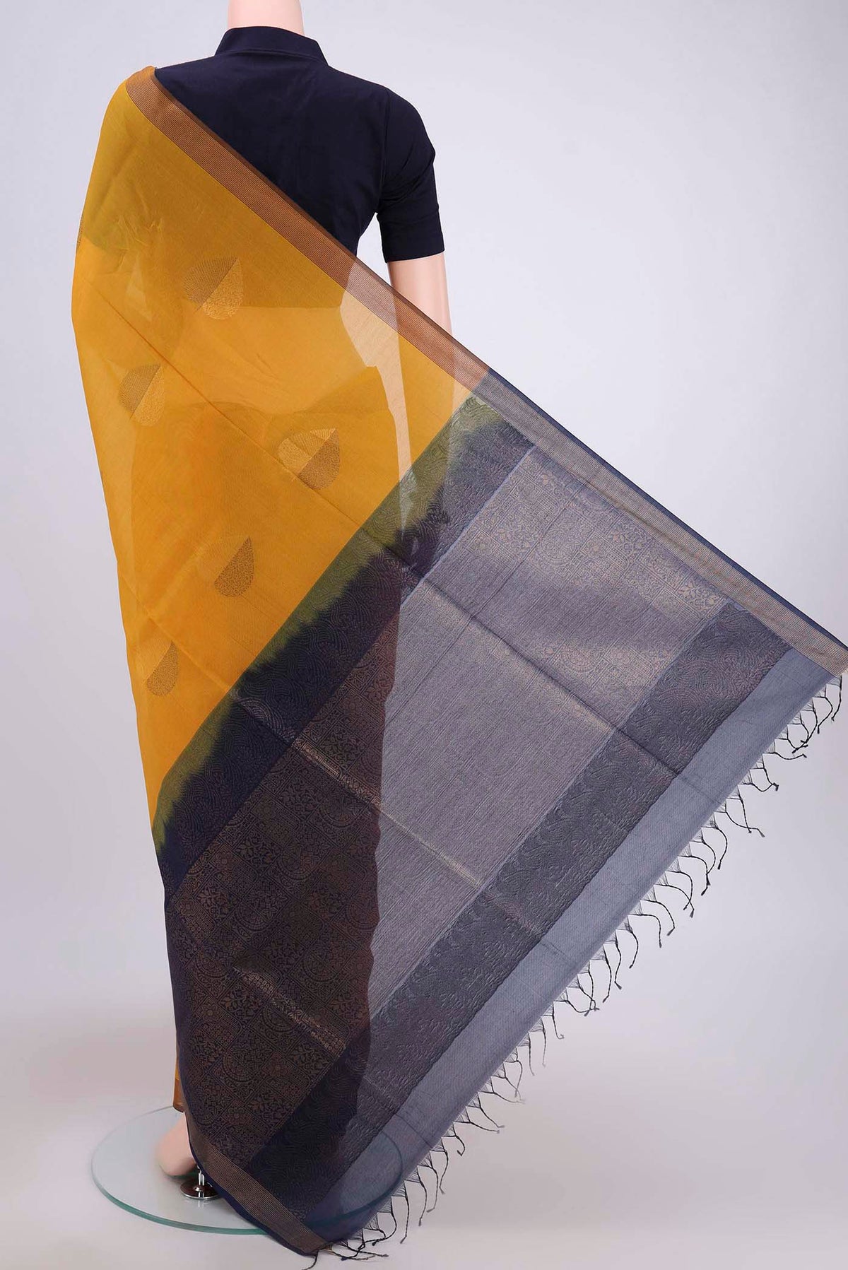 Flat view of Mustard Kora Cotton Saree with Zari Butta on the body and Plain Border. 