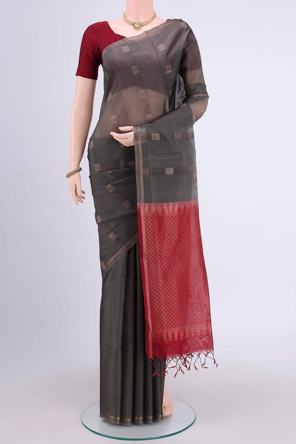 Davys Grey Kora Cotton Saree with Zari Butta on the body and Zari Border.  displayed on a mannequin