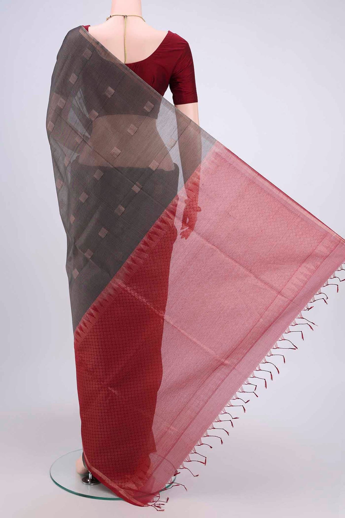 Flat view of Davys Grey Kora Cotton Saree with Zari Butta on the body and Zari Border. 