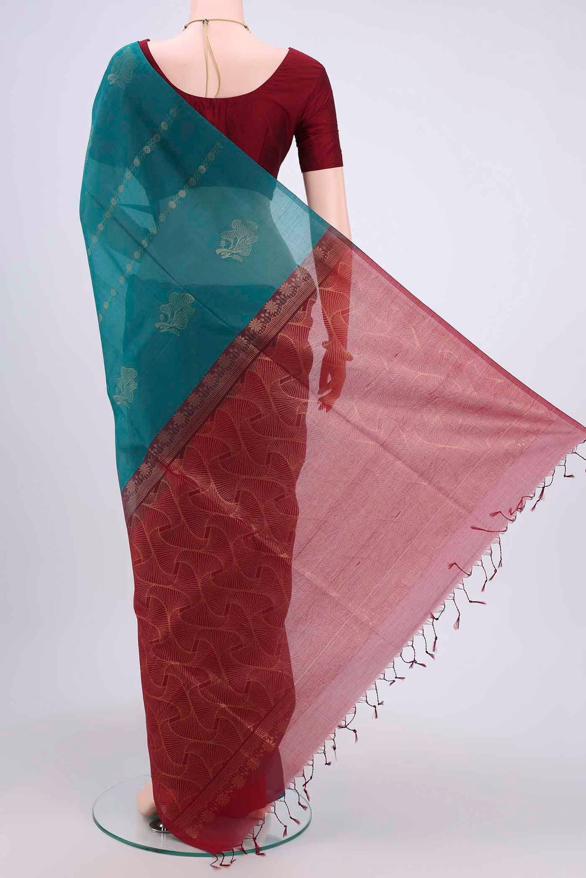 Flat view of Sea Green Kora Cotton Saree with Zari Butta on the body and Zari Border. 