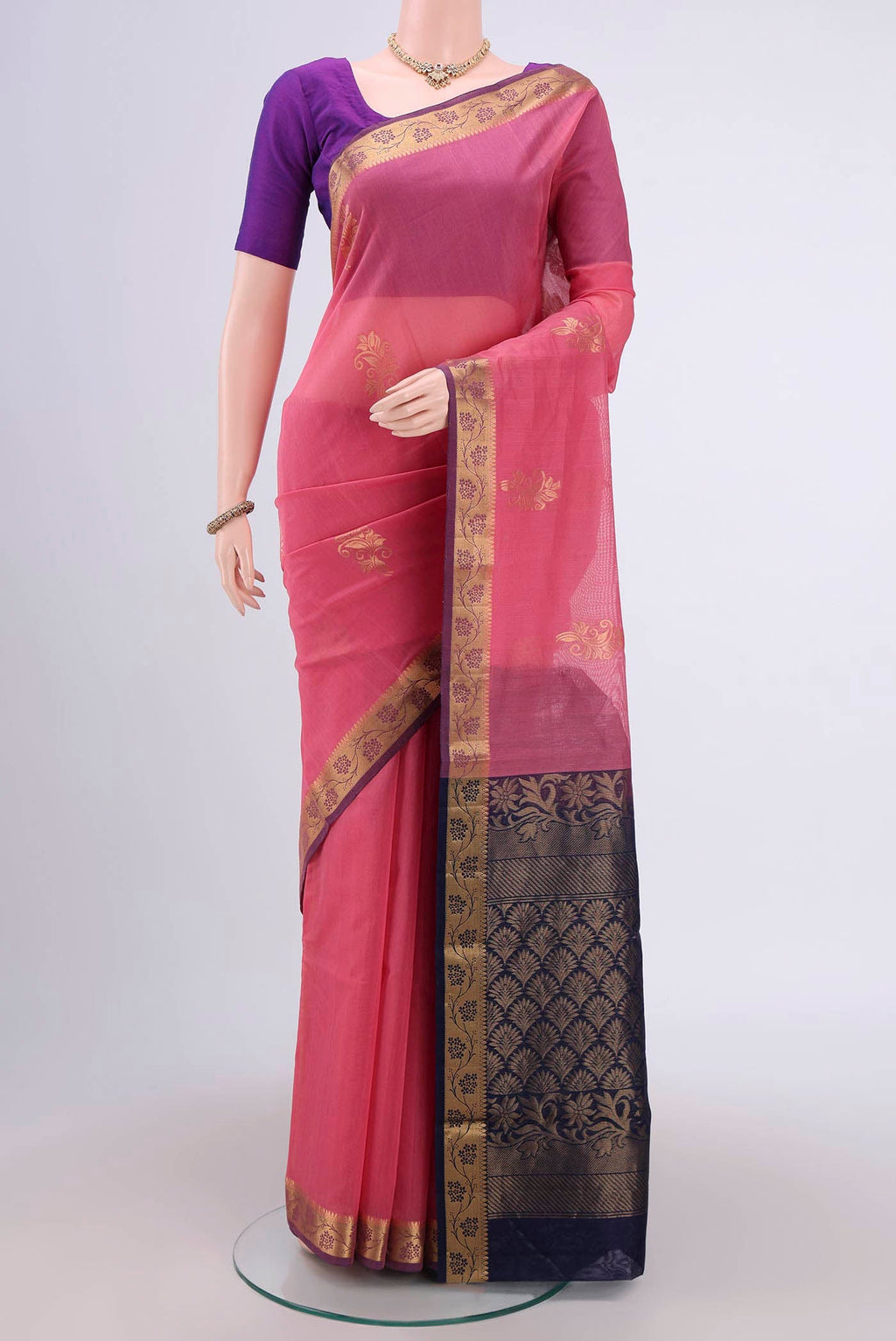 Pink Silk Cotton Saree with Zari Butta on the body and Zari Border.  displayed on a mannequin