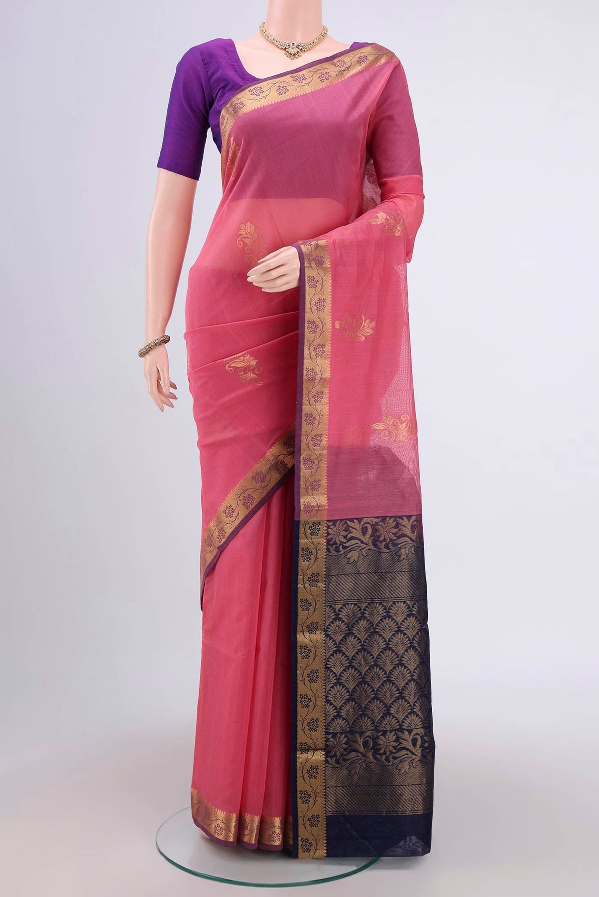 Pink Silk Cotton Saree with Zari Butta on the body and Zari Border.  displayed on a mannequin