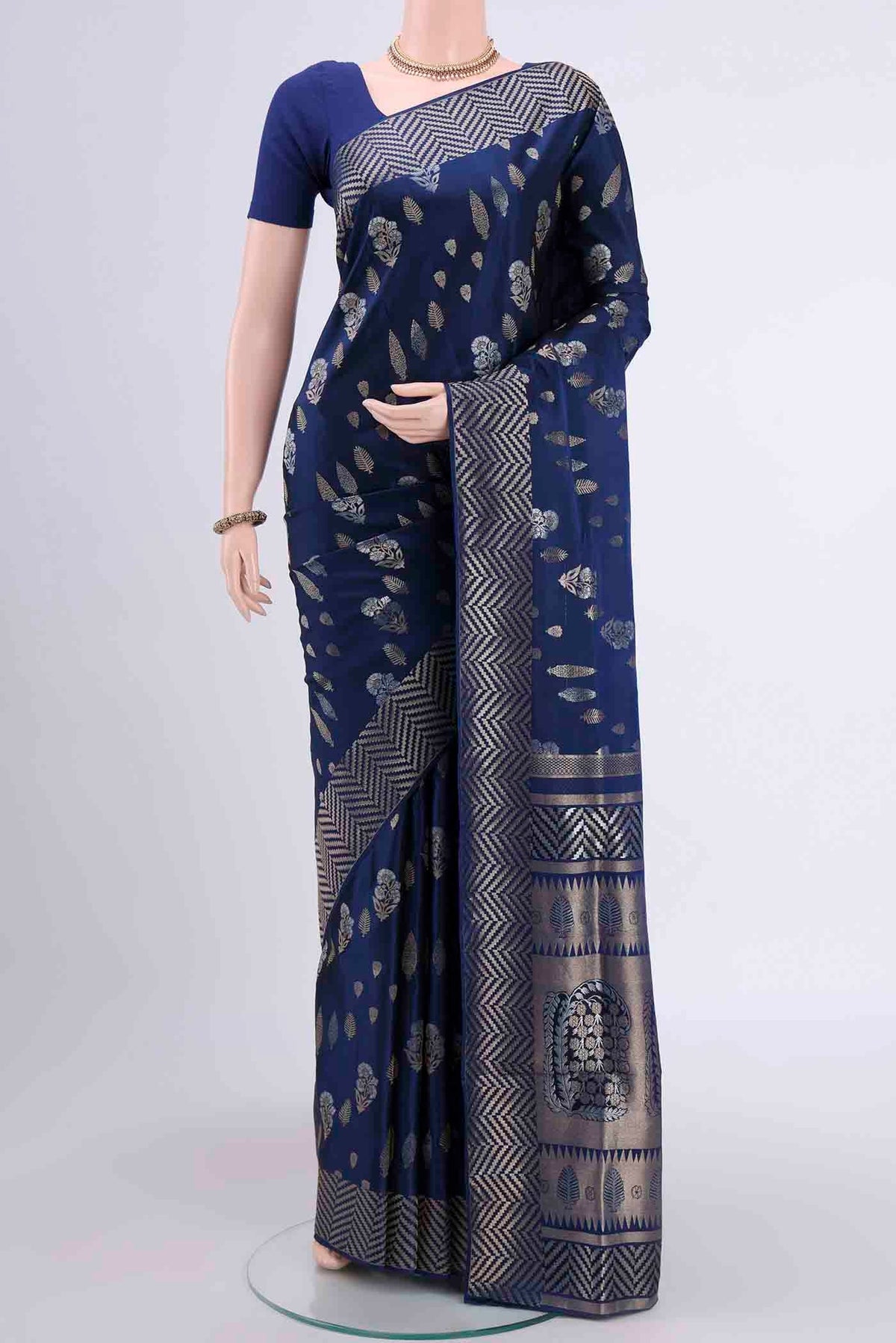 Navy Blue Soft Silk Saree with Zari Butta on the body and Zari Border displayed on a mannequin