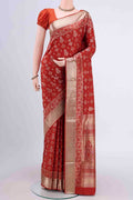 Rust Soft Silk Saree with Zari Butta on the body and Zari Border displayed on a mannequin
