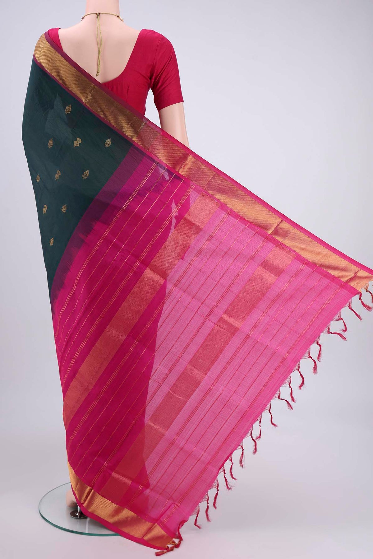 Flat view of Bottle Green Blended Poly Cotton Saree with Zari Butta on the body and Thread Border. 