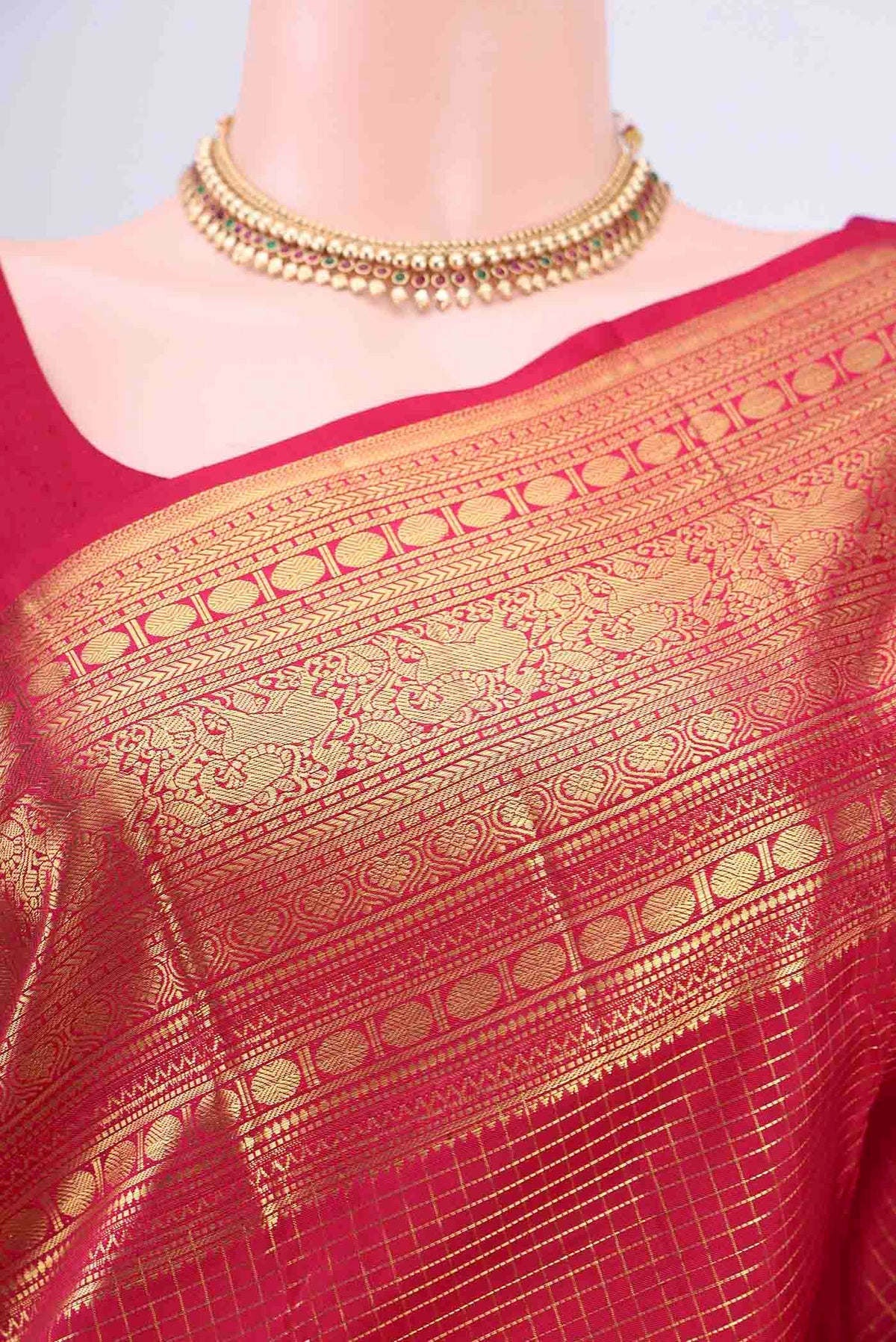 Border image of Maroon Kanjivaram Saree with Checked design on the body and Zari Border. 