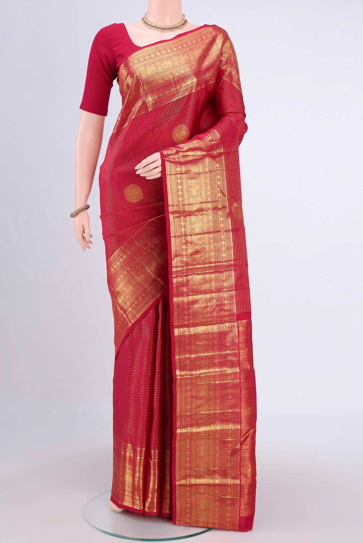Maroon Kanjivaram Saree with Checked design on the body and Zari Border.  displayed on a mannequin