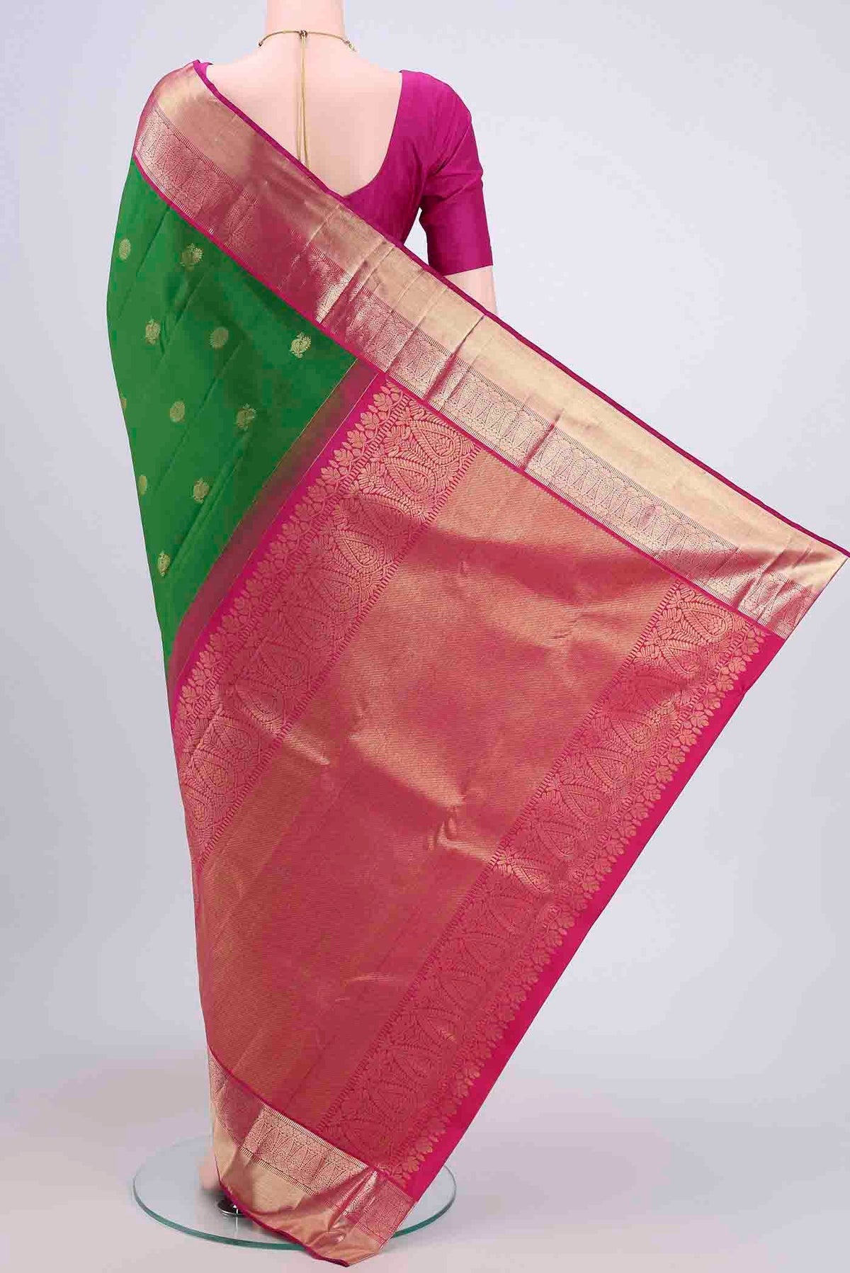 Flat view of Green Kanchipuram Saree with Zari Butta on the body and Zari Border