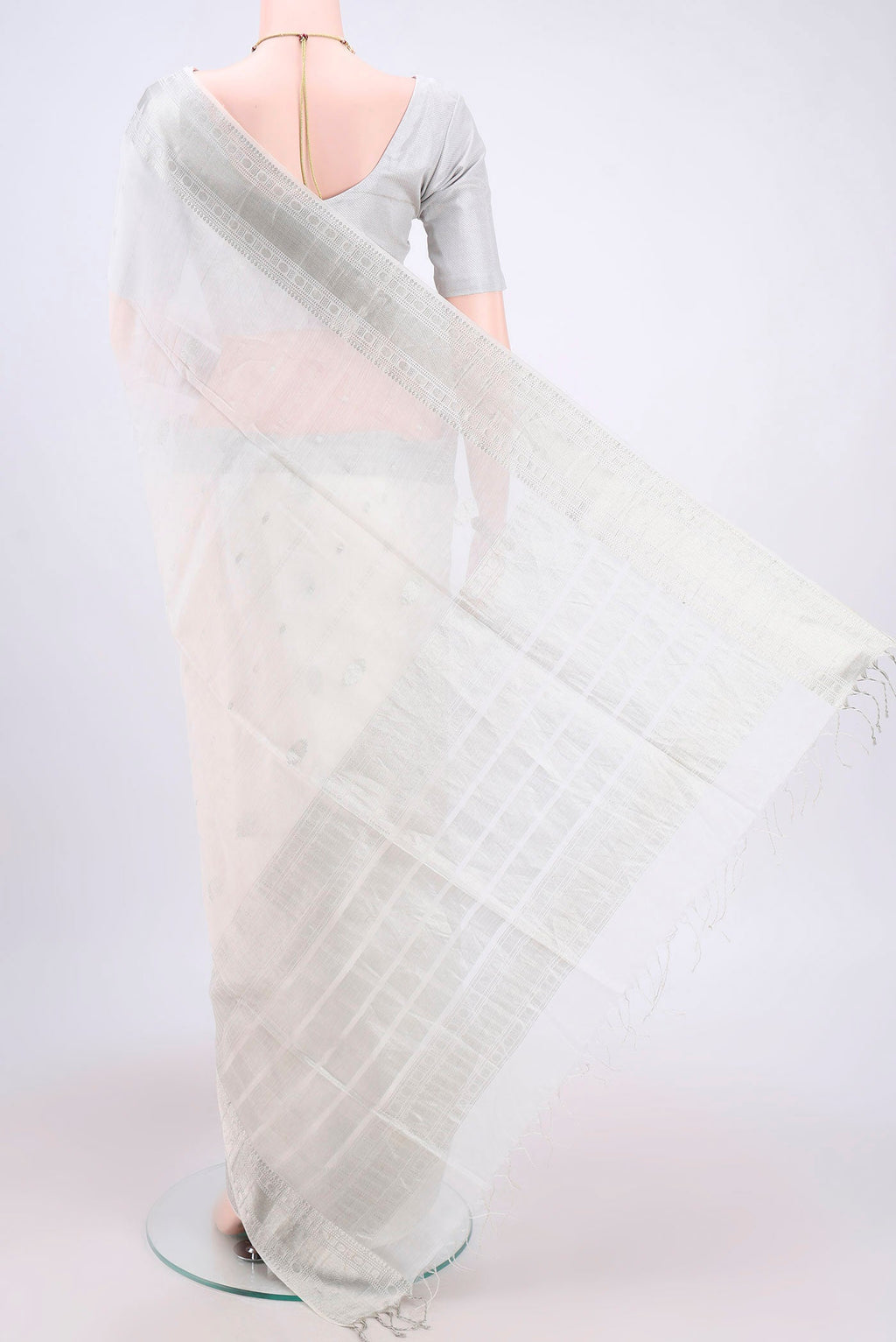 Flat view of White Kora Cotton Saree with Zari Butta on the body and Plain Border. 