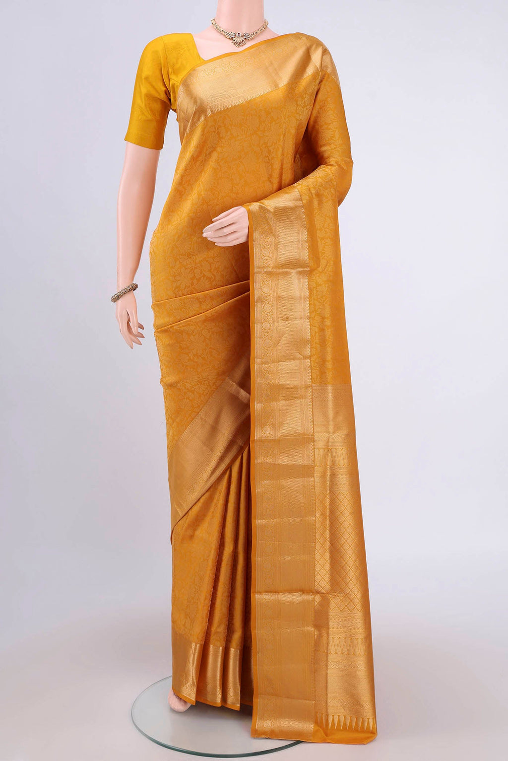 Mustard Soft Silk Saree with Zari Brocade on the body and Zari Border.  displayed on a mannequin