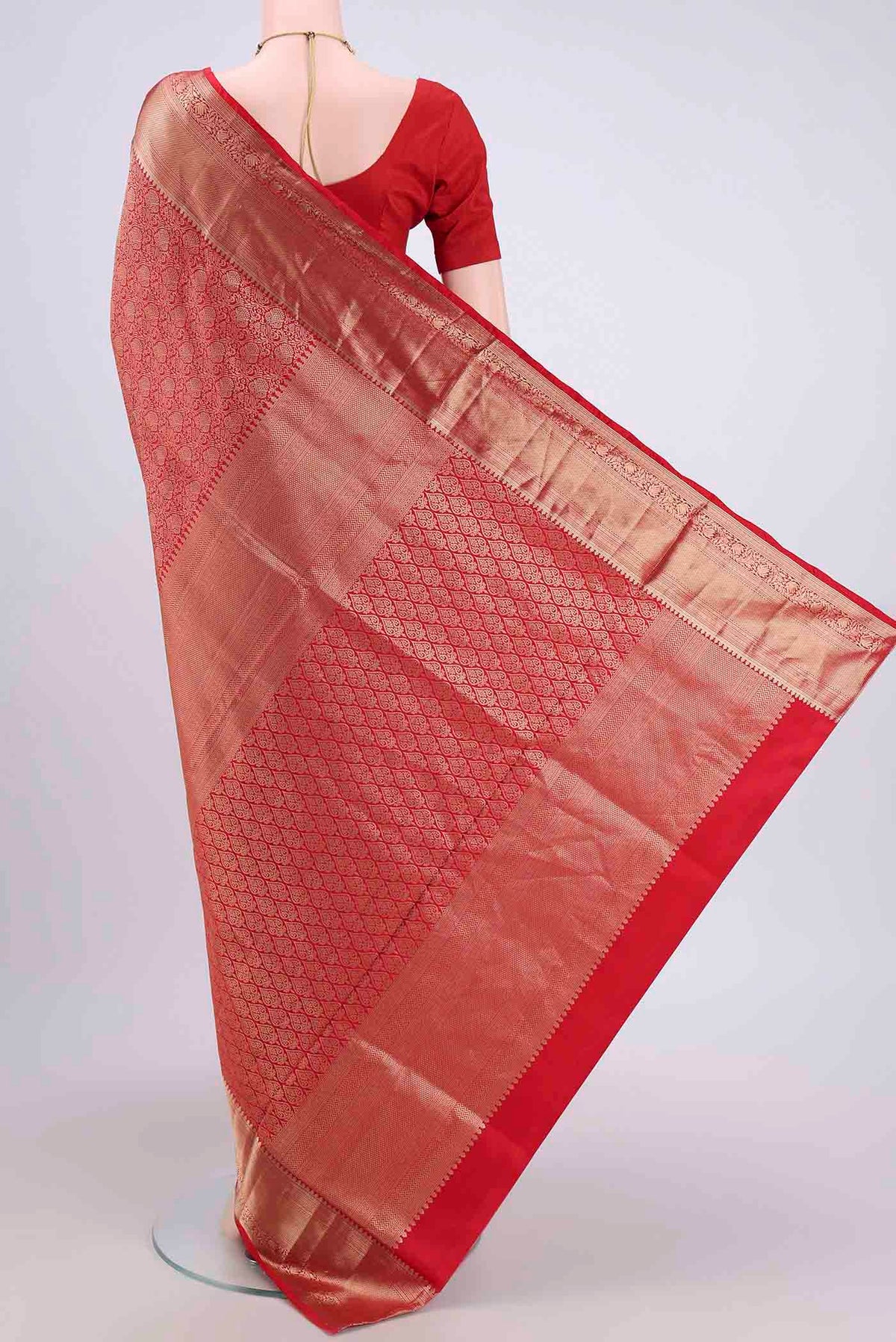 Flat view of Red Soft Silk Saree with Zari Brocade on the body and Zari Border. 