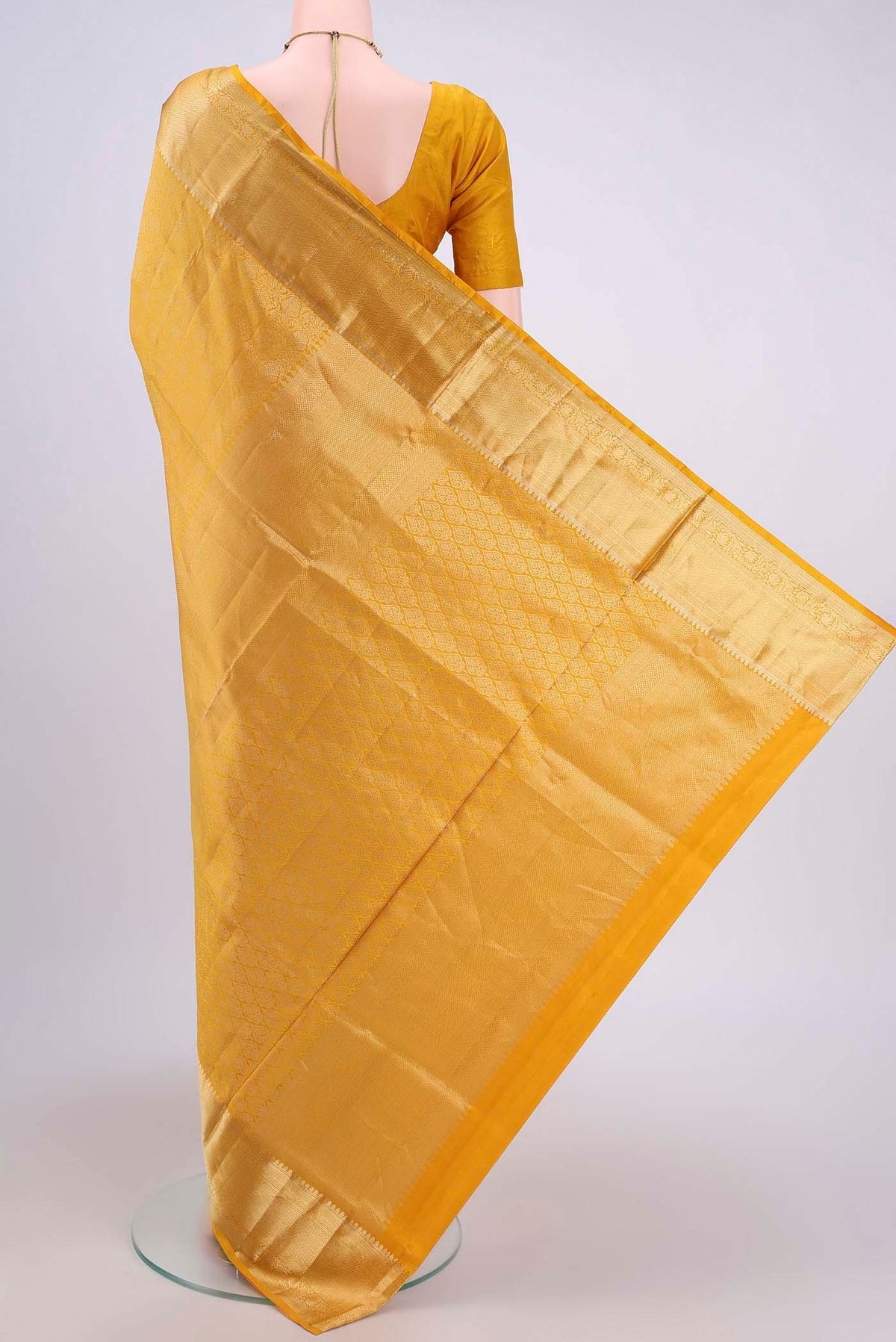Flat view of Mustard Soft Silk Saree with Zari Brocade on the body and Zari Border. 