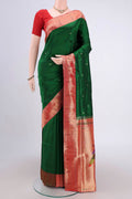 Green Soft Silk Saree with Zari Butta on the body and Zari Border.  displayed on a mannequin