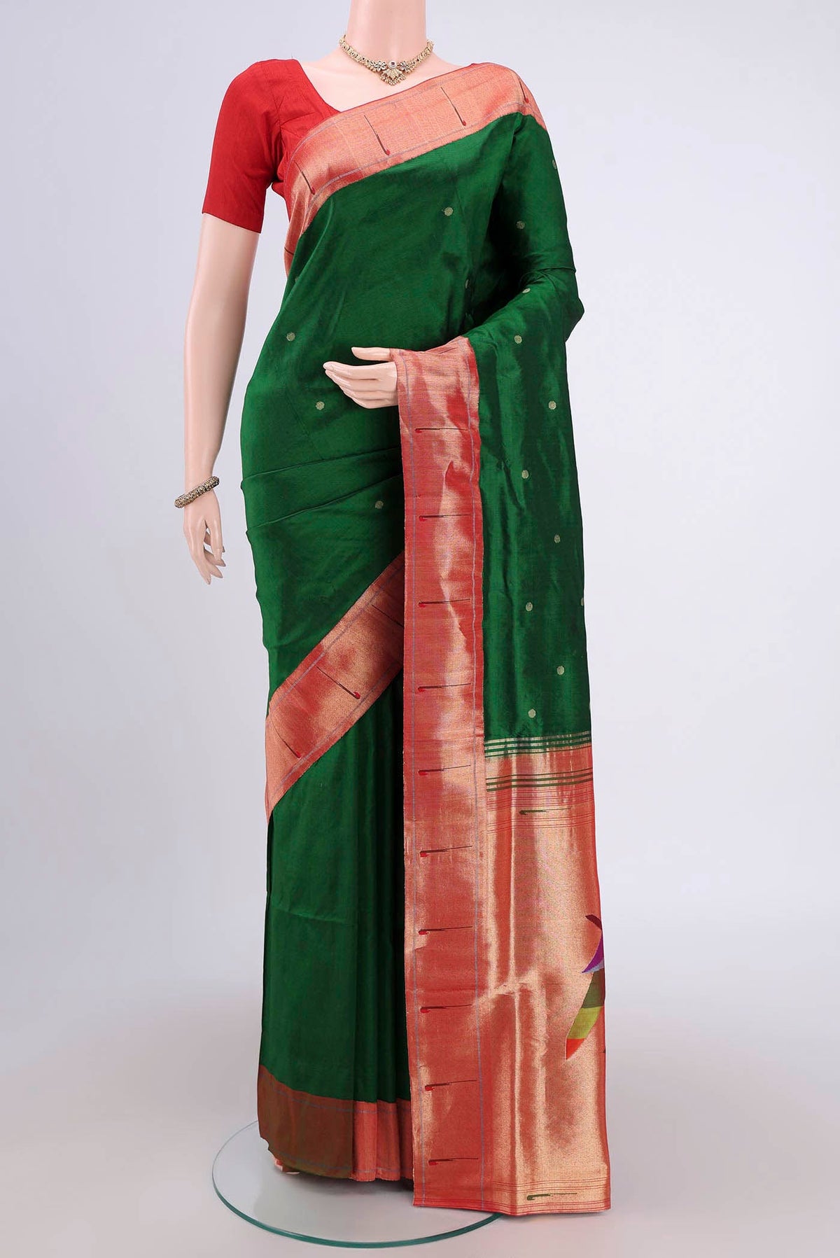 Green Soft Silk Saree with Zari Butta on the body and Zari Border.  displayed on a mannequin
