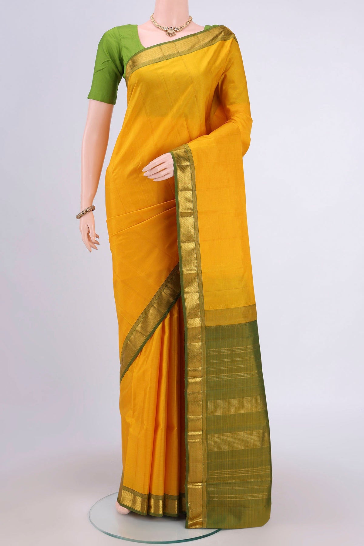 Lemon Yellow Dual Tone Kanjivaram Saree with Plain Body and Zari Border.  displayed on a mannequin