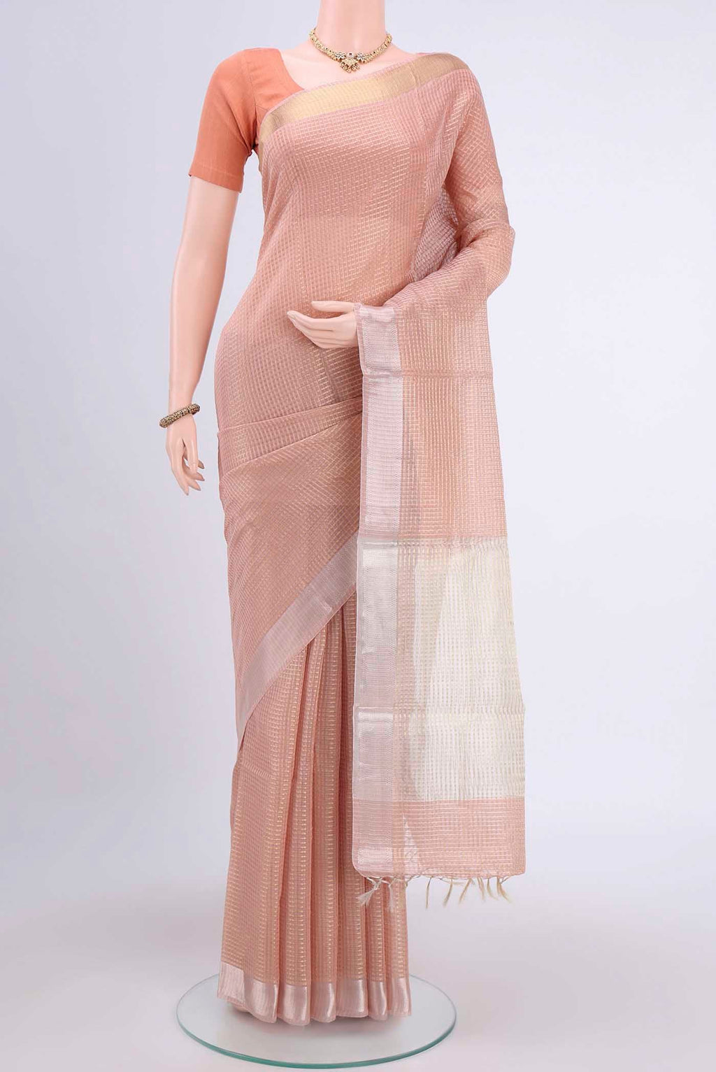 Peach Tussar Silk Saree with Checked design on the body and Plain Border.  displayed on a mannequin