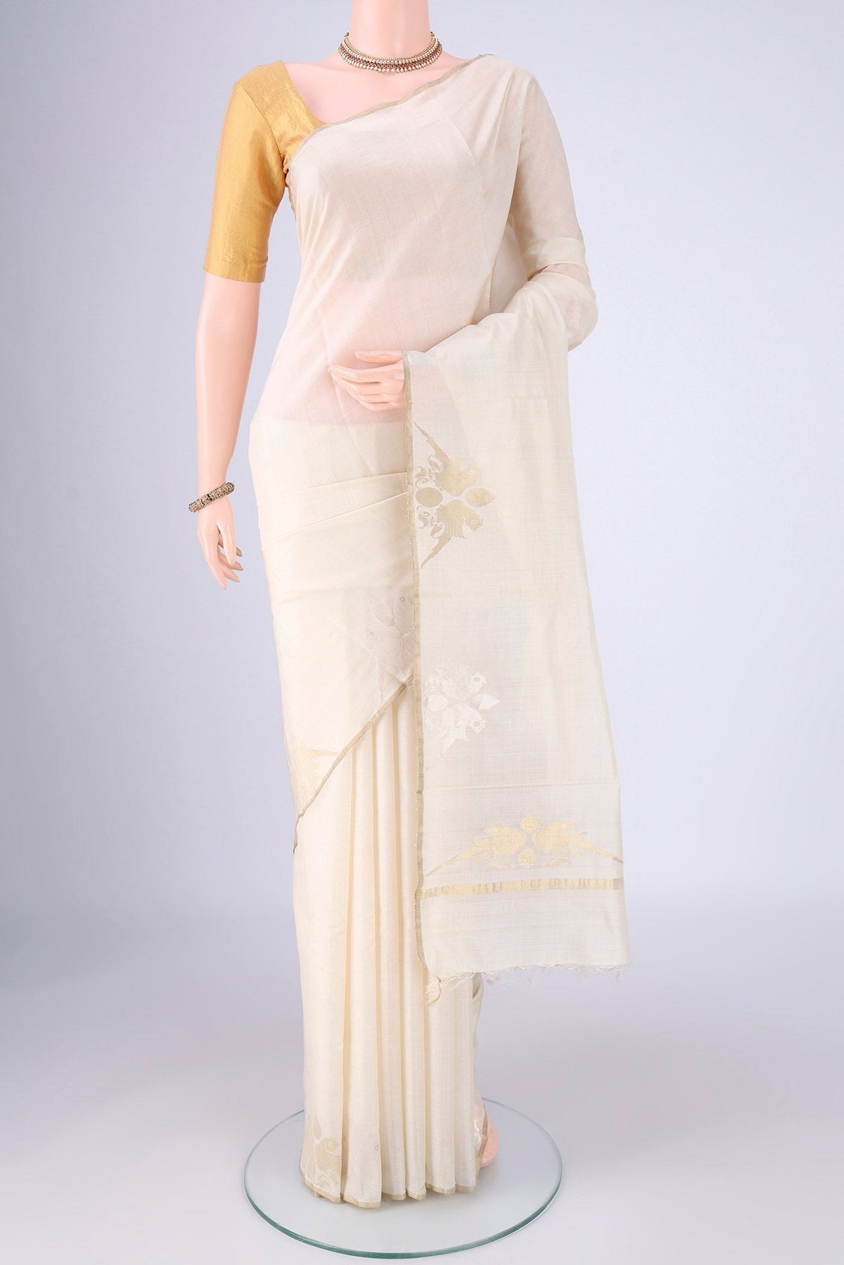 Off White MP Tussar Saree with Plain Body and Zari Border.  displayed on a mannequin
