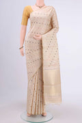 Beige Tussar Silk Saree with Zari And Thread Butta on the body and Thin Zari Line.  displayed on a mannequin