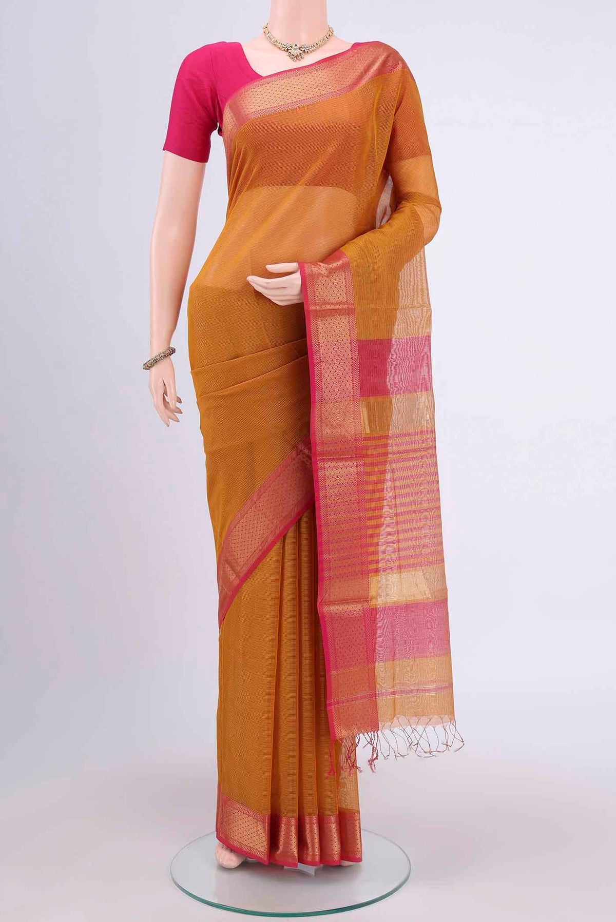 Mustard Tussar Silk Saree with Thread Butta on the body and Zari Border.  displayed on a mannequin