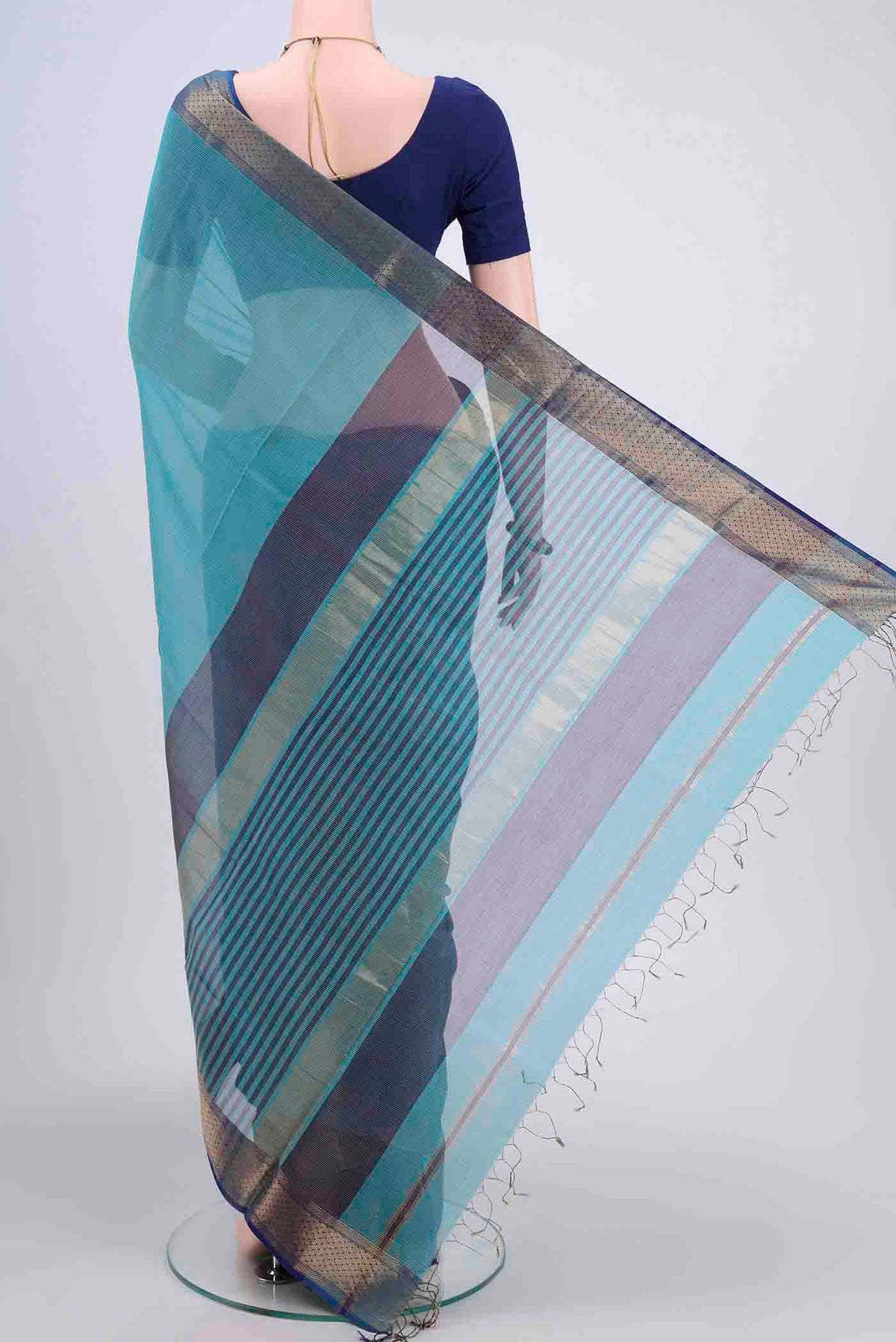 Flat view of Turquoise Tussar Silk Saree with Thread Butta on the body and Zari Border. 