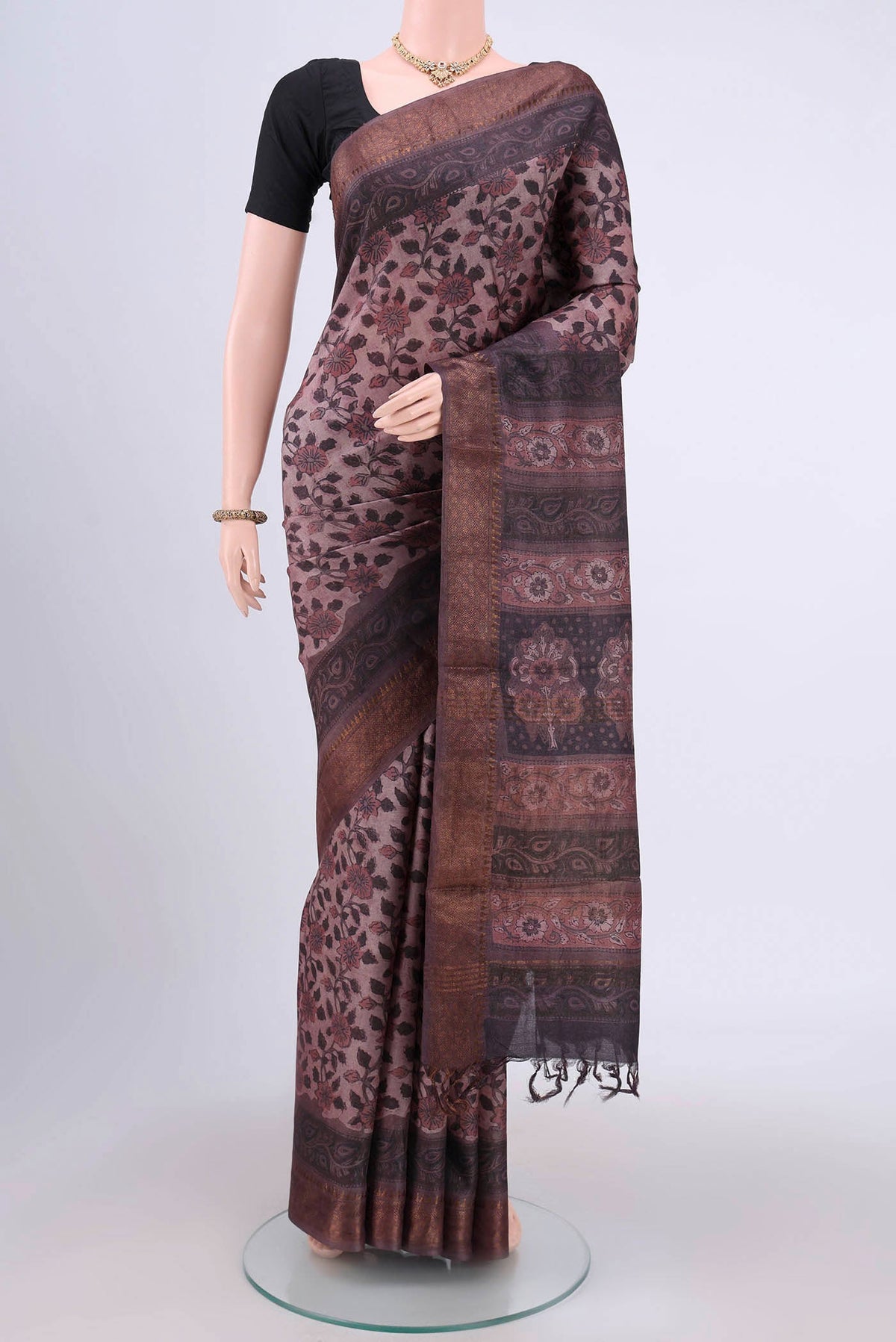 Dark Mauve Tussar Silk Saree with kalamkari Print on the body and Zari Border.  displayed on a mannequin