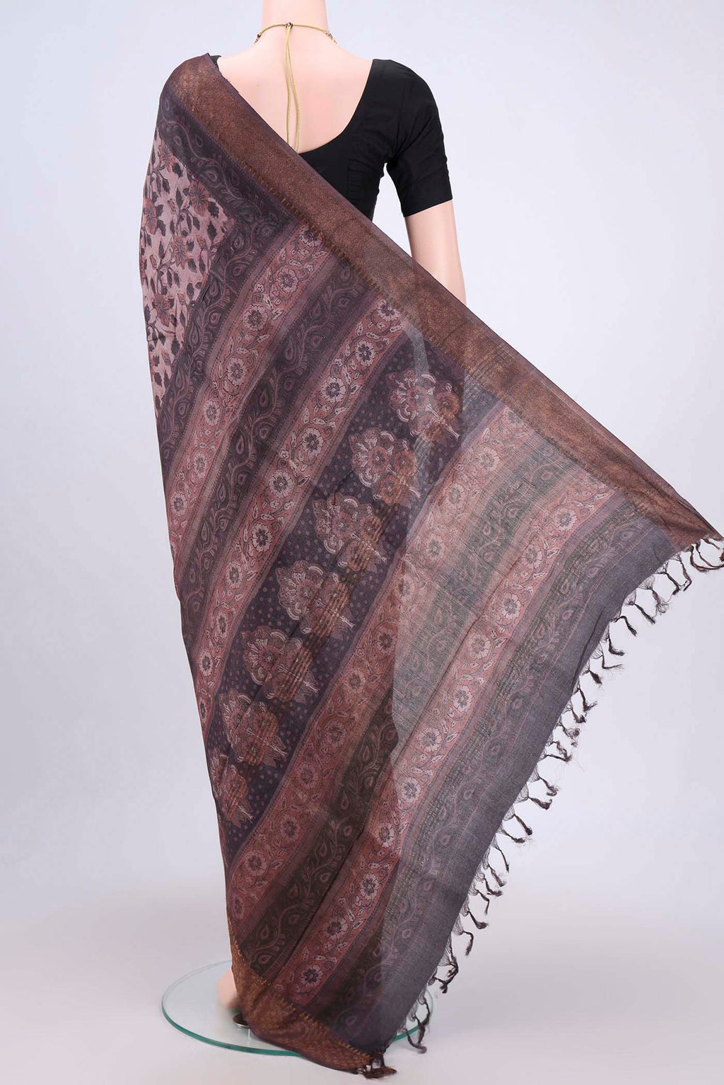 Flat view of Dark Mauve Tussar Silk Saree with kalamkari Print on the body and Zari Border. 