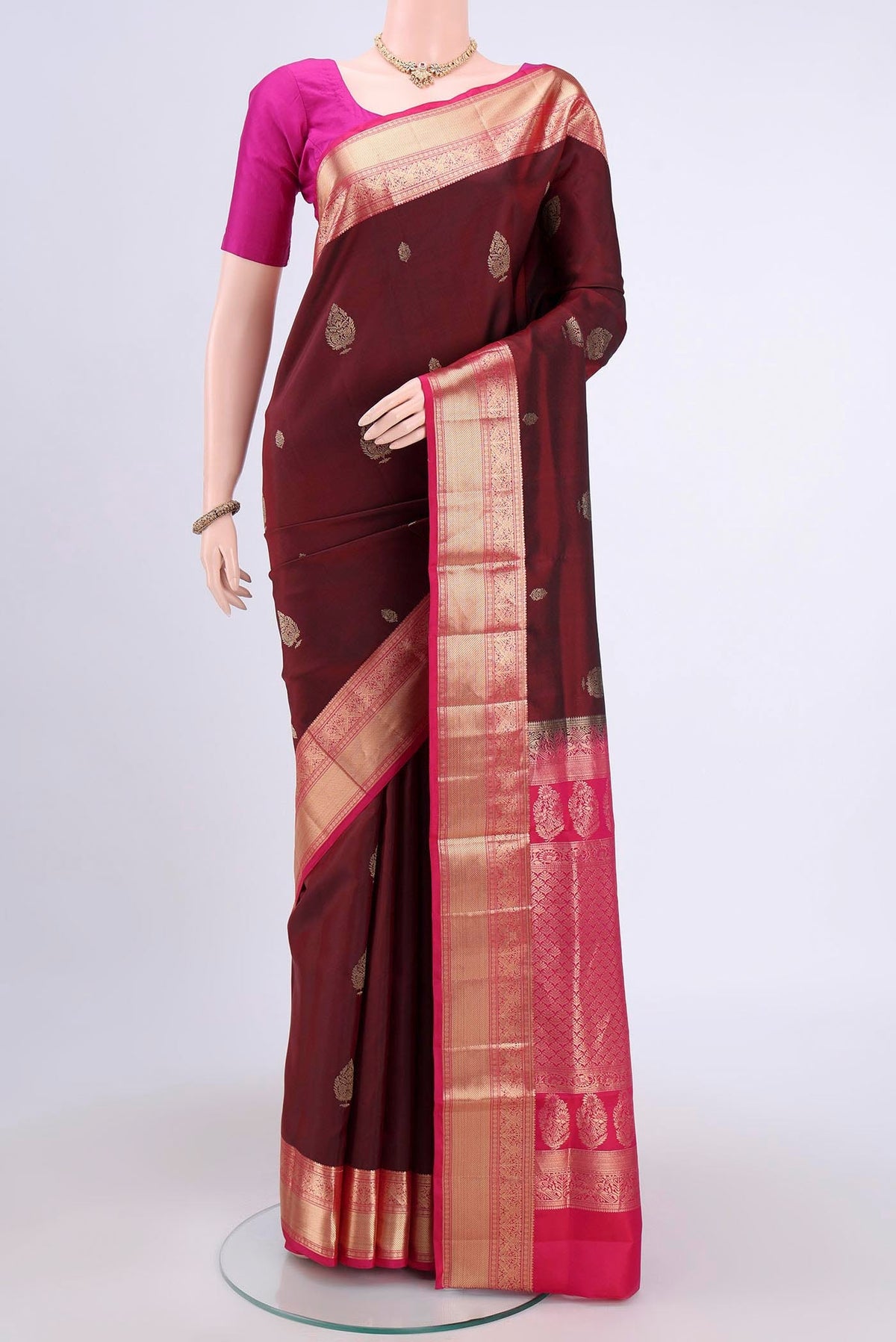 Maroon Soft Silk Saree with Zari Butta on the body and Zari Border.  displayed on a mannequin