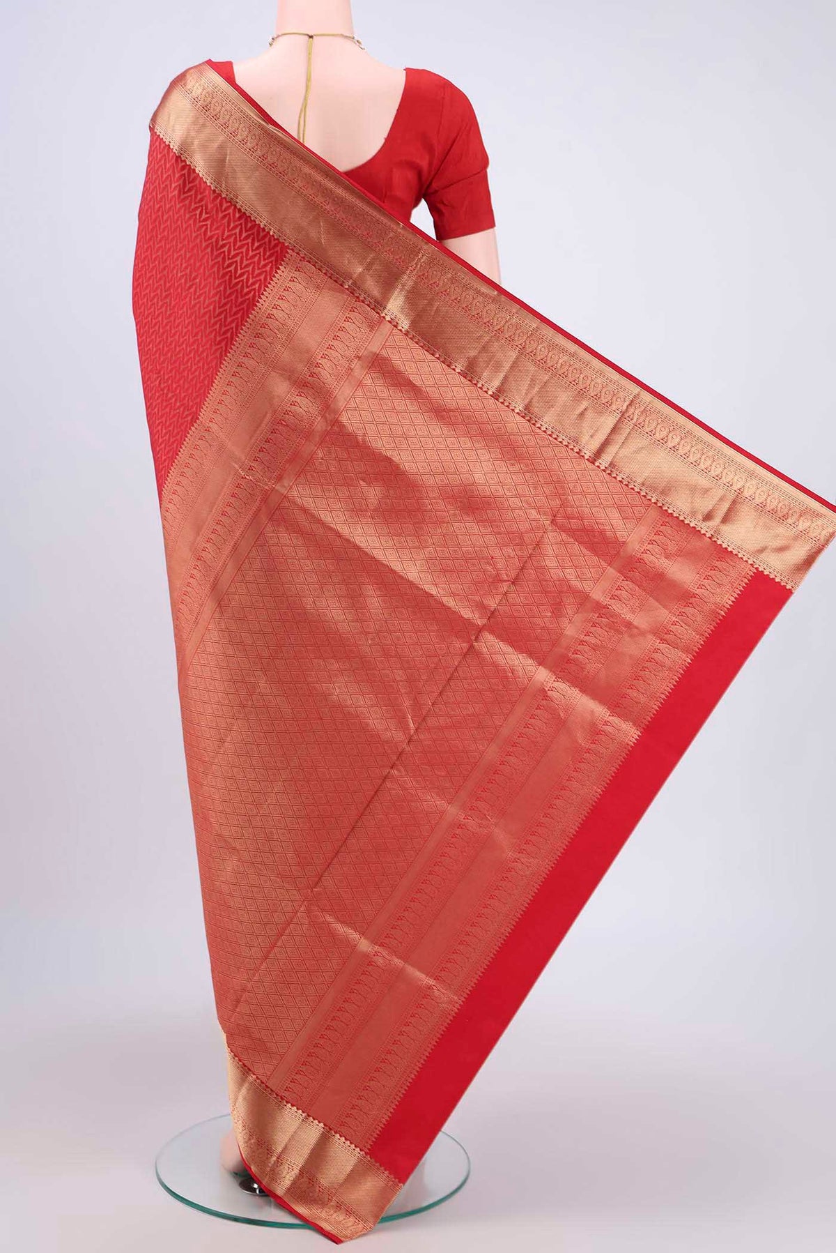 Flat view of Red Soft Silk Saree with Zig Zag design on the body and Zari Border. 
