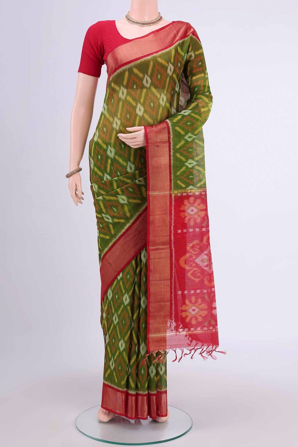 Mehandi Green Kora Cotton Saree with Ikat design on the body and Zari Border displayed on a mannequin