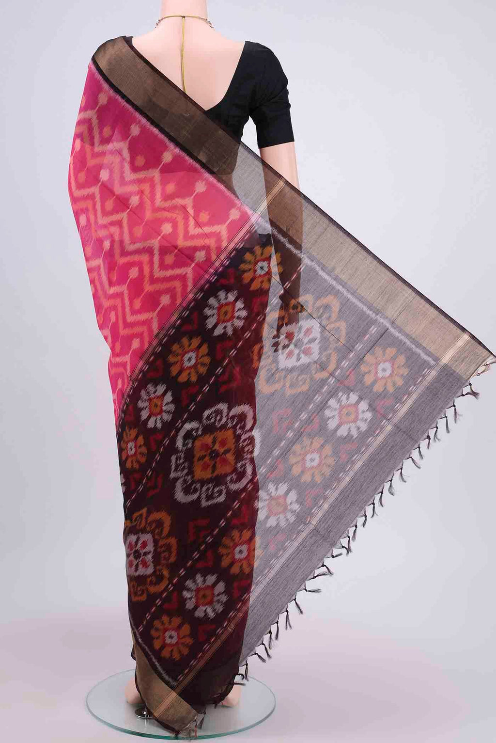 Flat view of Rani Pink Kora Cotton Saree with Ikat design on the body and Zari Border