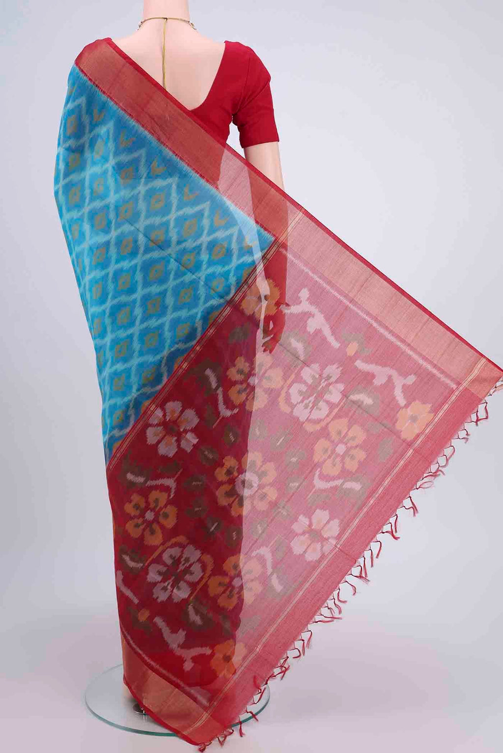 Flat view of Blue Kora Cotton Saree with Ikat design on the body and Zari Border