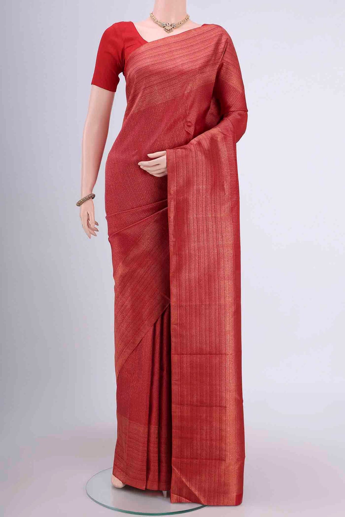 Red Dual Tone Kanchipuram Saree with Zari Brocade on the body and Zari Border displayed on a mannequin
