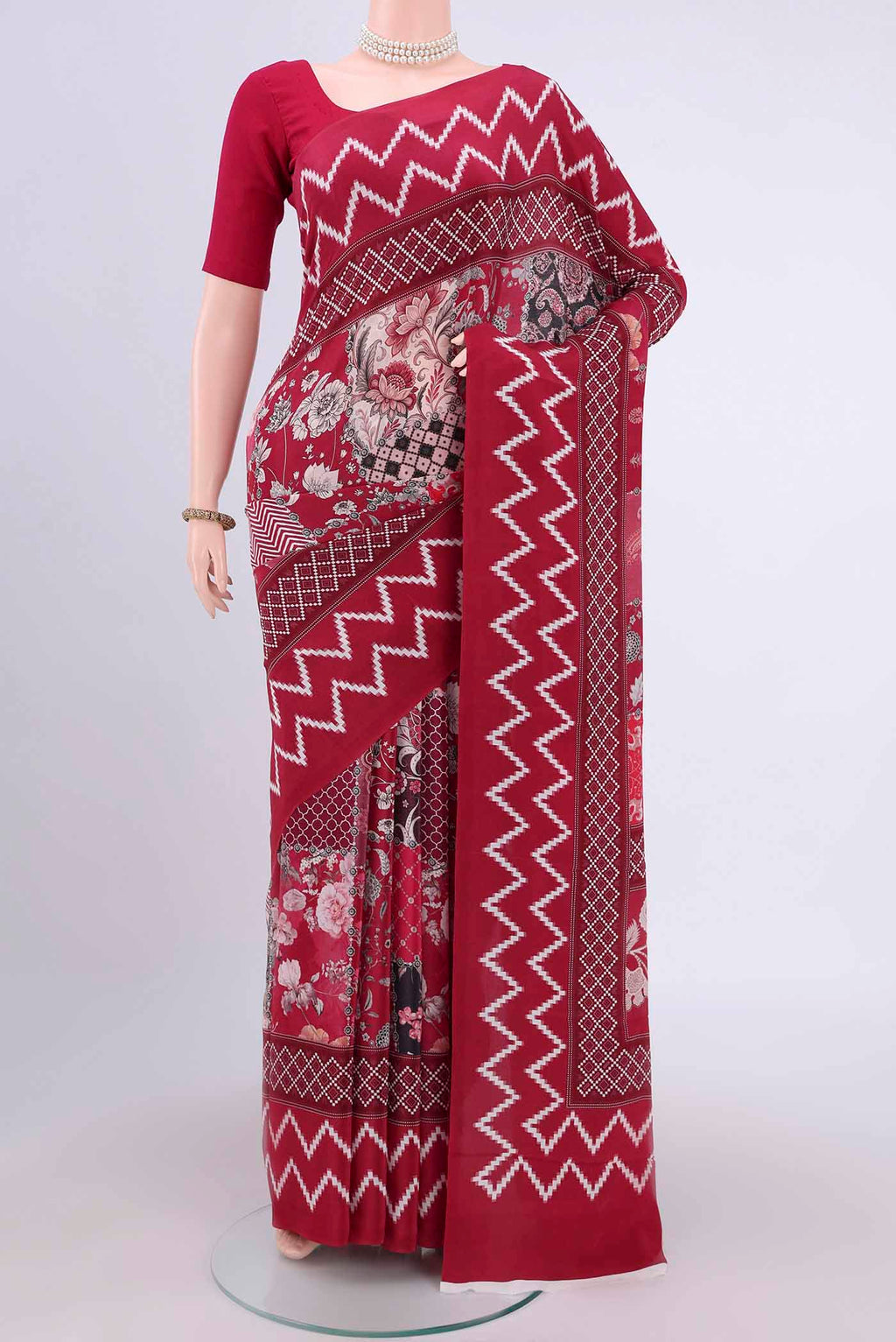 Maroon Crepe Saree with Floral Print on the body and Plain Border.  displayed on a mannequin