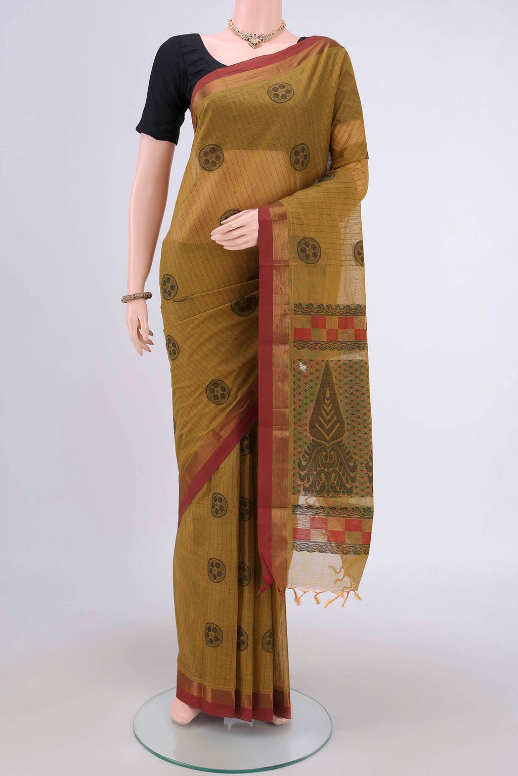 Mustard Kanchi Cotton Saree with Stripes on the body and Zari Border.  displayed on a mannequin