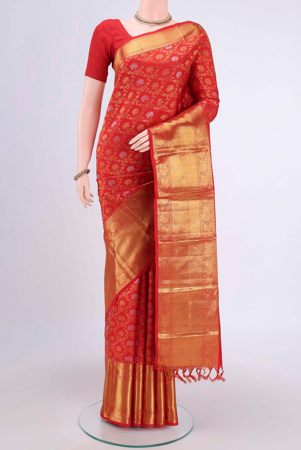 Red Kanchipuram Saree with Zari Brocade on the body and Zari Border.  displayed on a mannequin