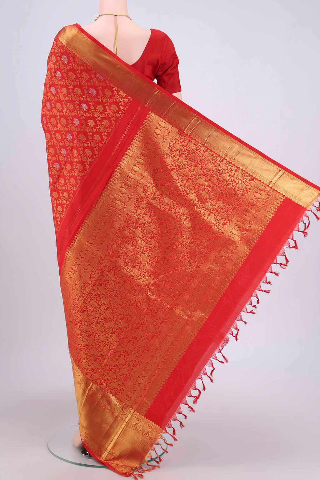 Flat view of Red Kanchipuram Saree with Zari Brocade on the body and Zari Border. 