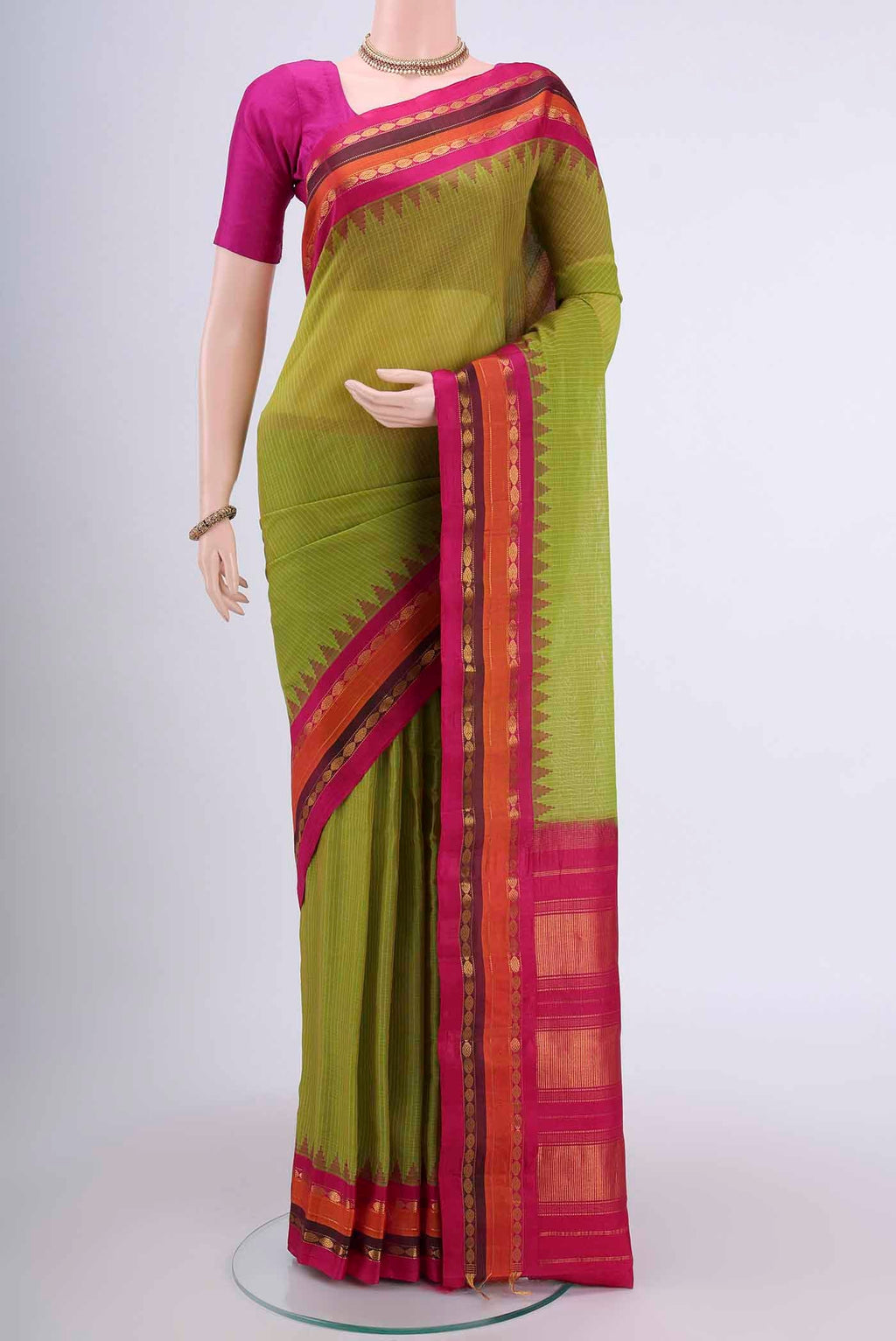 Light Green Gadwal Silk Saree with Stripes on the body and Zari Border displayed on a mannequin