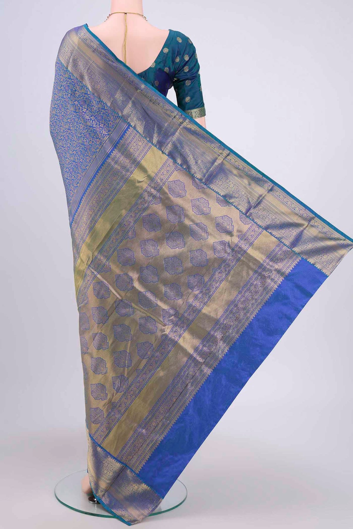 Flat view of Peacock Blue Bangalore Silk Saree with Zari Brocade on the body and Zari Border. 